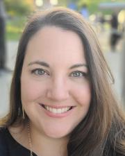 Headshot of Sarah looking directly at camera with a smile